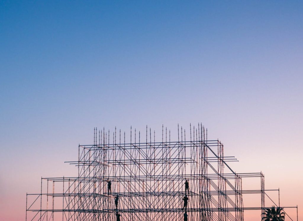 pexels-photo-1117452 A silhouetted structure against a colorful sunset, showcasing industrial scaffolding in Sochi, Russia.